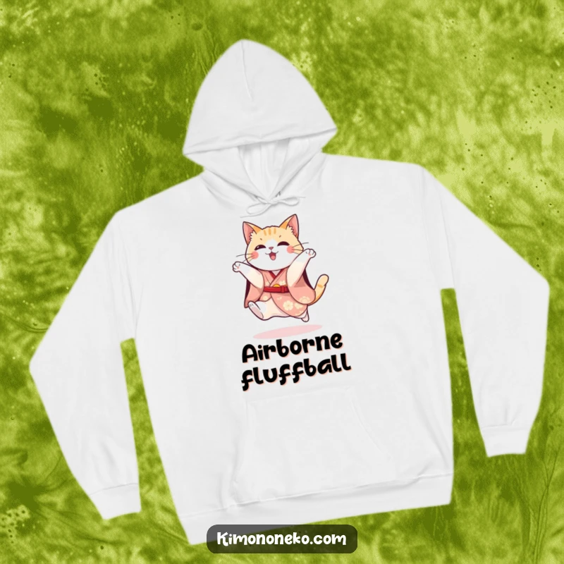 Funny hoodie showing a playful cat in a festive kimono attempting a spirited jump, radiating energy and humor.