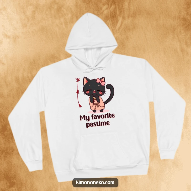 Funny Kawaii black cat in a simple kimono, batting a string, presented on a cozy hoodie for ultimate comfort and humor.