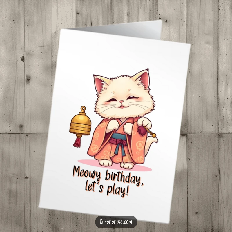 Funny Free Printable Birthday Card: Fluffy kawaii cat in a kimono playfully bats at a dangling bell.
