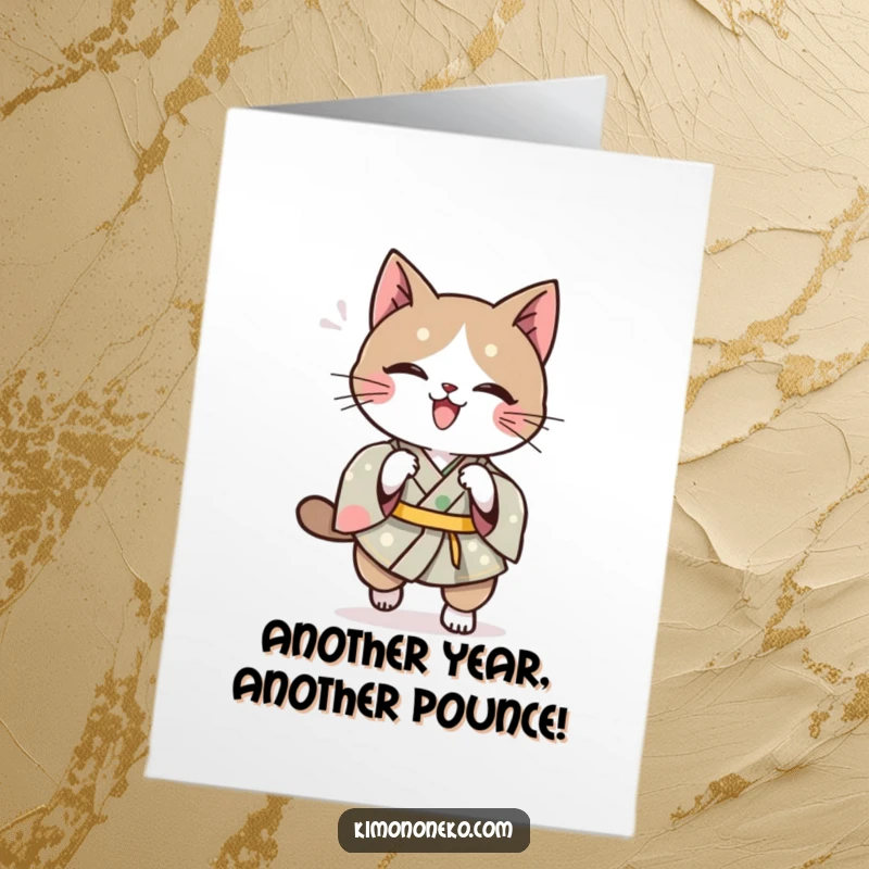 Funny Free Printable Birthday Card: Kawaii cat in a traditional kimono executes a playful, agile pounce with mischievous intent.
