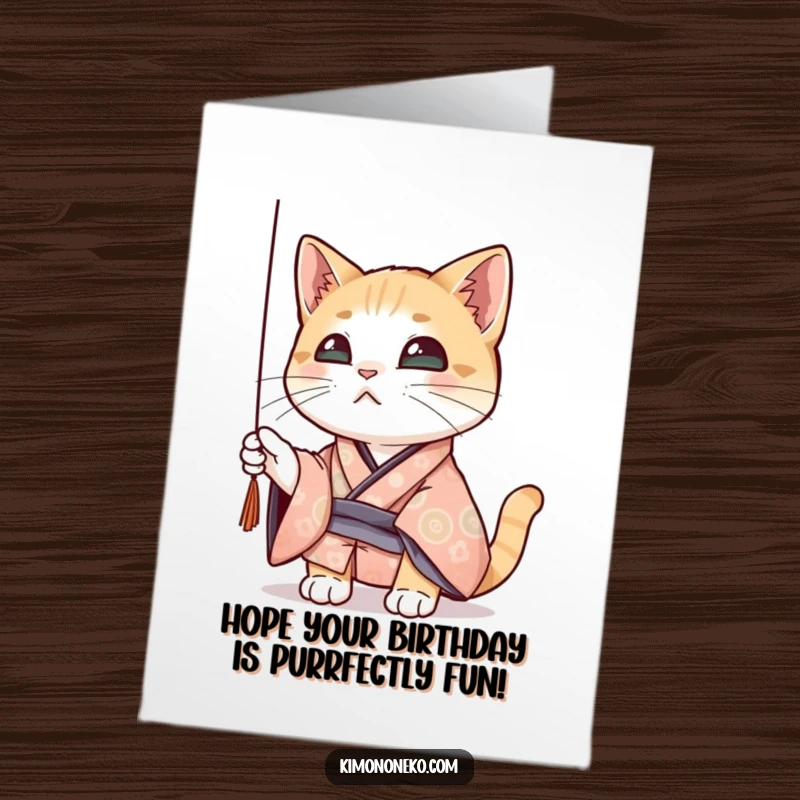 Funny Free Printable Birthday Card: A curious cat in a patterned kimono playfully bats at a dangling thread.