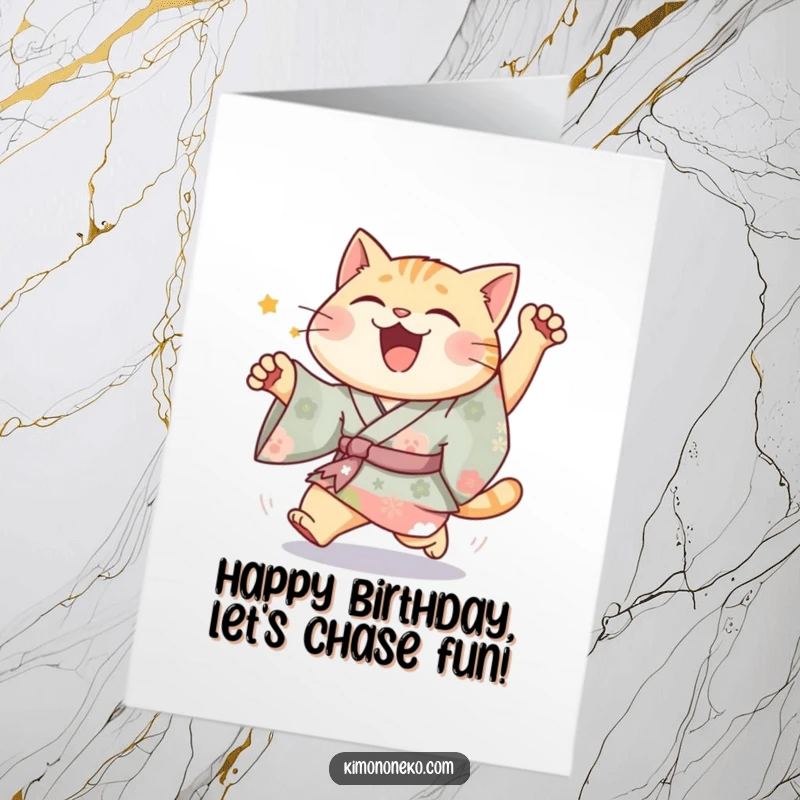 Funny Free Printable Birthday Card: A joyful cat in a vibrant kimono energetically chases something unseen.