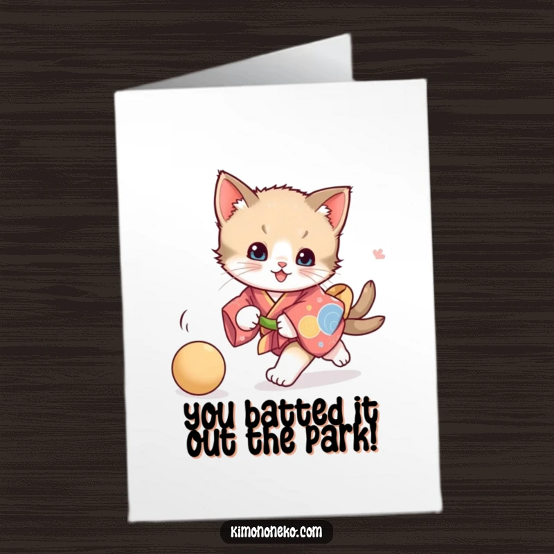 Funny Free Printable Kitten Congratulations Card of a kitten in a vibrant kimono chasing a ball, symbolizing enthusiastic success.