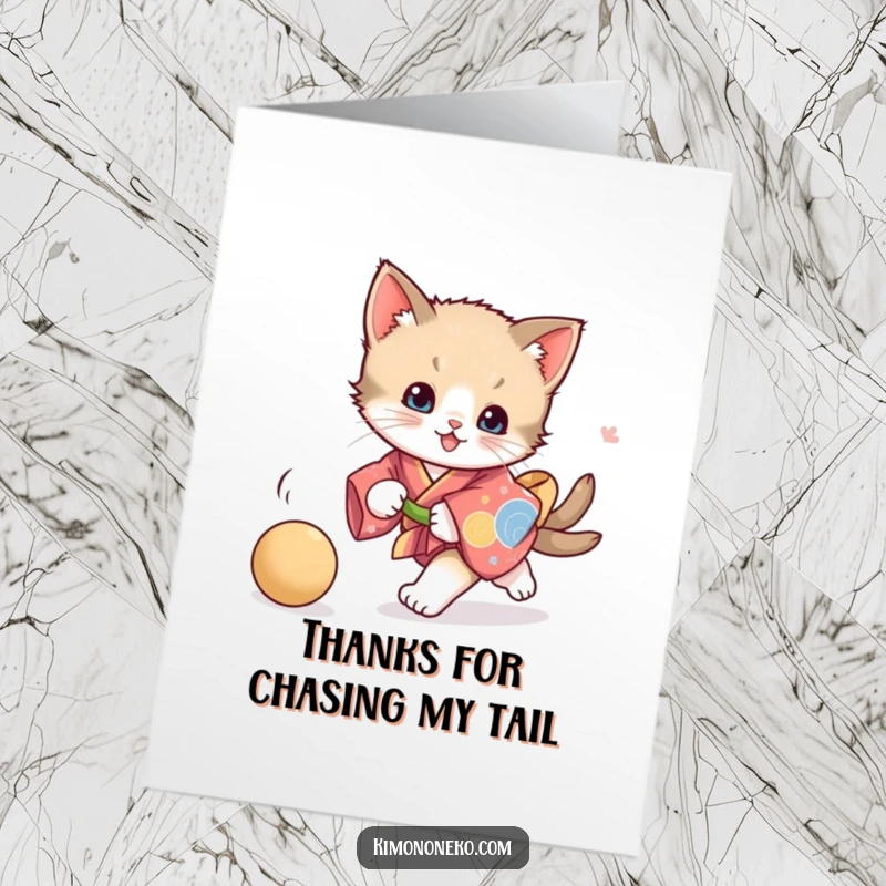 Funny Free Printable Kitten Thank You Card depicting a playful kitten in a vibrant kimono chasing a ball, conveying thanks.