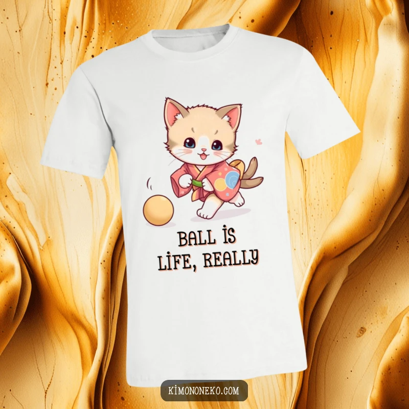 Funny playful kitten t-shirt, depicting a kitten in a vibrant kimono in pursuit of a ball, embodying energetic fun and feline charm.