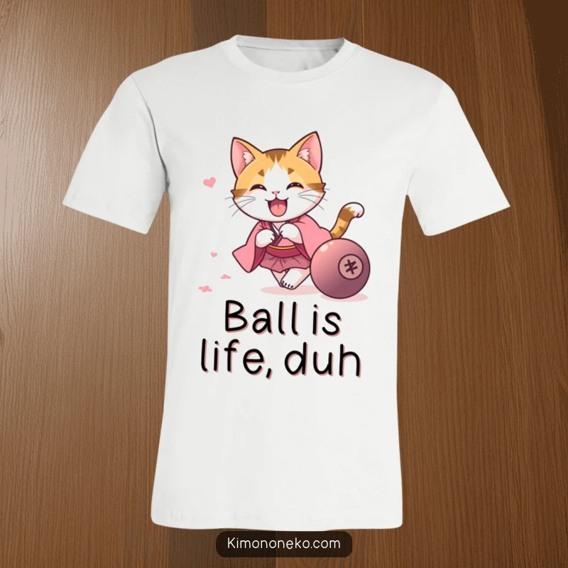 Funny kawaii calico cat in a pink kimono, energetically chasing a rolling ball, on a comfortable and funny t-shirt.