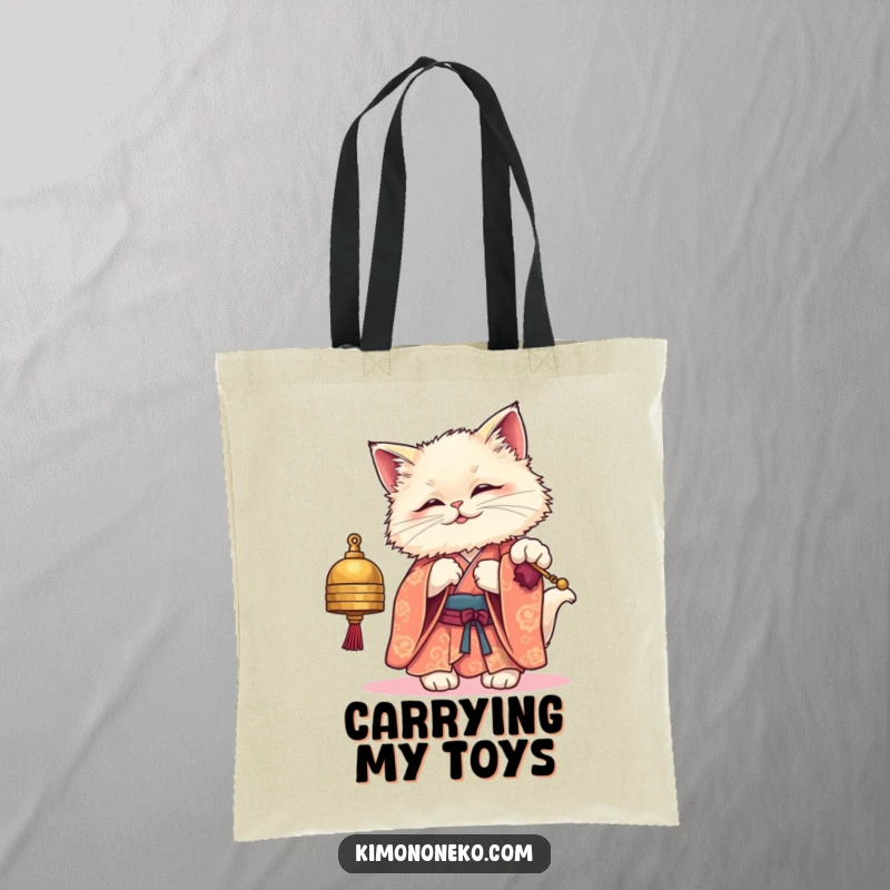 Funny tote bag featuring a fluffy kawaii cat in an elegant kimono, playfully engaging with a small bell, ideal for everyday use.