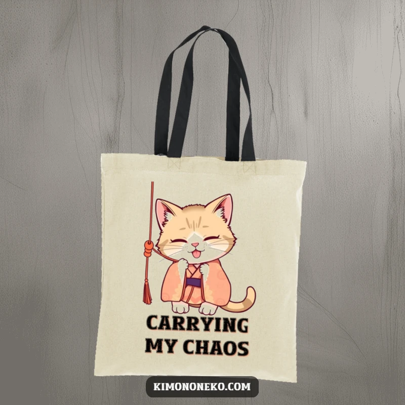 Funny tote bag displaying a mischievous cat in a patterned kimono, actively batting at a dangling silk cord, showcasing its playful and naughty nature.